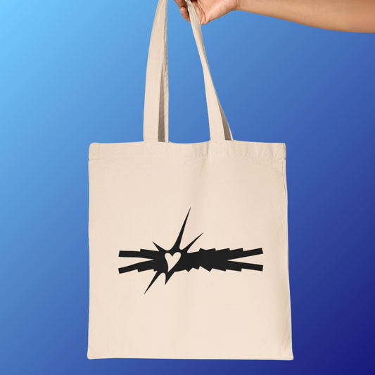 Fearnot holding Lesserafim tote bag featuring logo design of ‘Crazy’