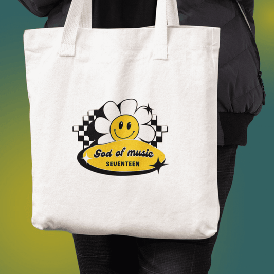 Carat holding Seventeen god of music canvas tote bag front view, featuring a retro design with a smiley flower design.